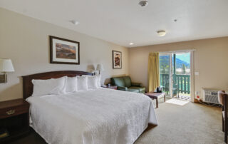 hotel with a king size bed and green couch
